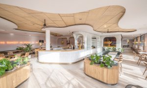 Jamie Oliver Kitchen Berlin - foto taken just before the official opening, nor guest or staff. Early sunday morning light, oak, green upholstery, rattan ceiling, tropical plants, tiles. Portugese flair paired with nordic design. designed by OOW architects in Berlin.